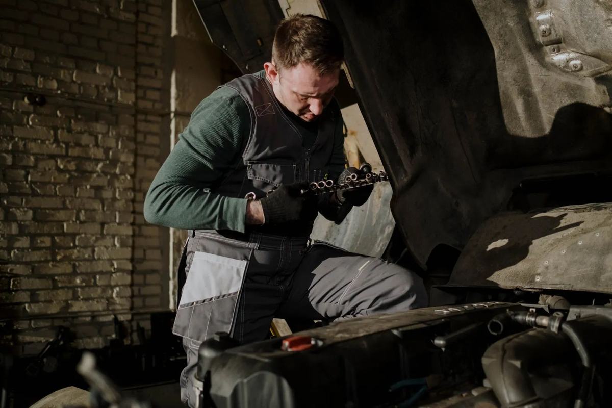 Mechanic with an engine part